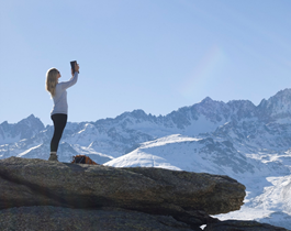 Femme avec tablette devant montagne